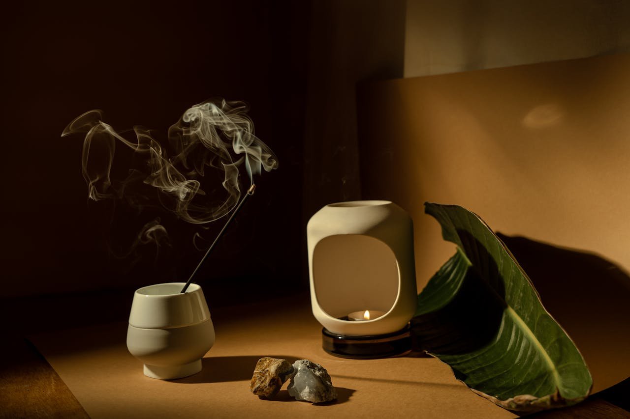 A calming still life featuring incense and tealight, perfect for relaxation and meditation.