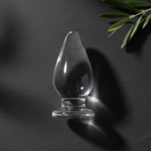 Clear tapered anal plug on slate